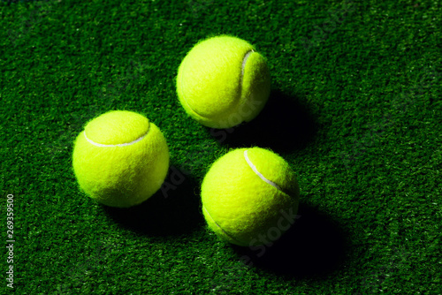 Tennis Ball isolated on green with dramatic lighting © The Len
