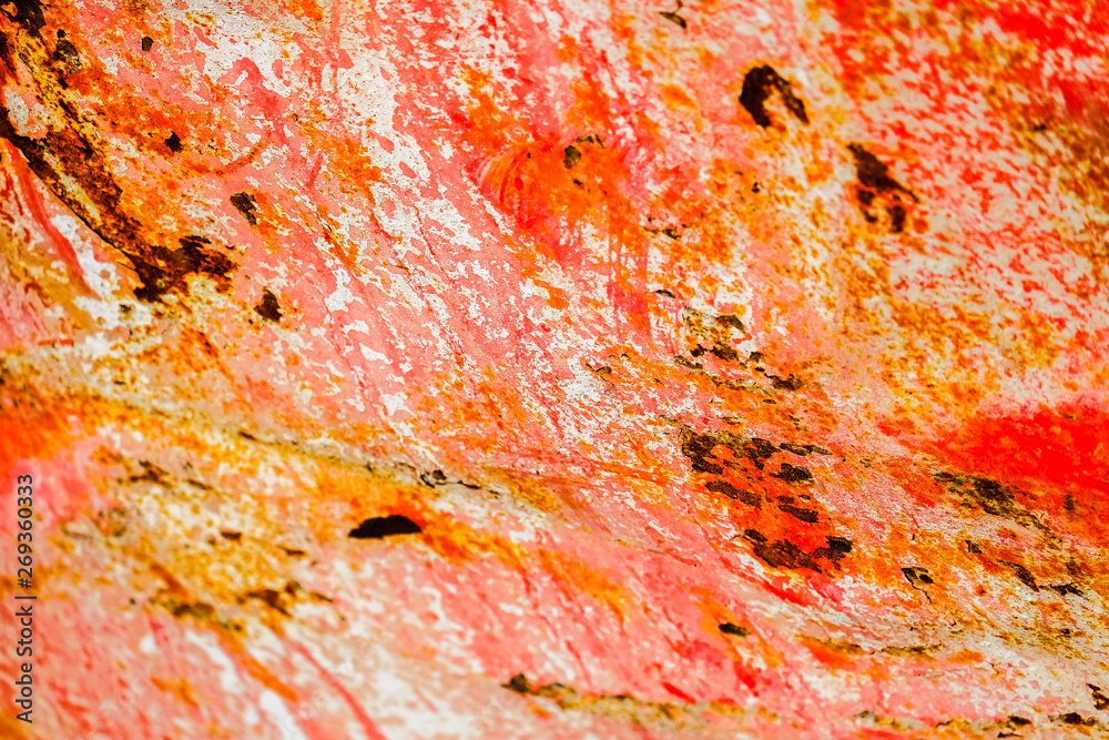 Old corroded metal wall background with flaky red paint .Rusty flaky cracked metal surface.Abstract the surface texture of the old metal.