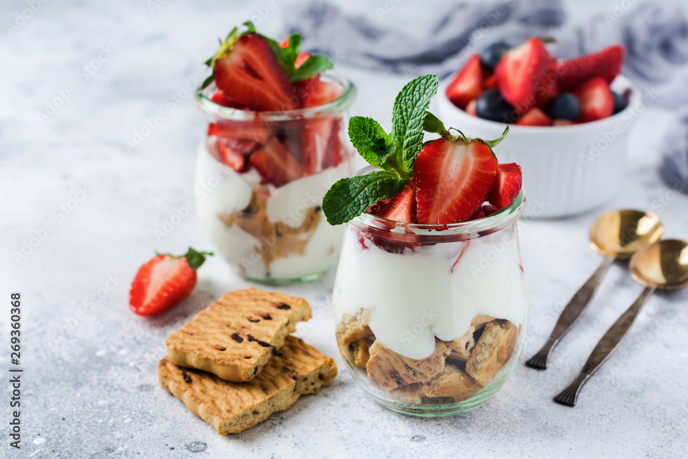No baked dessert treifl or cheesecake with strawberries in sliced jars on an old concrete background. Selective focus. No baked dessert treifl or cheesecake with strawberries in sliced jars on an old concrete background. Selective focus.