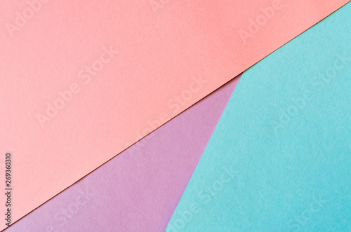 Multicolored paper background in soft blue, lilac and coral colors.