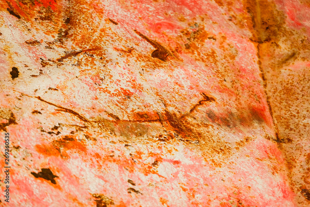Old corroded metal wall background with flaky red paint .Rusty flaky cracked metal surface.Abstract the surface texture of the old metal.