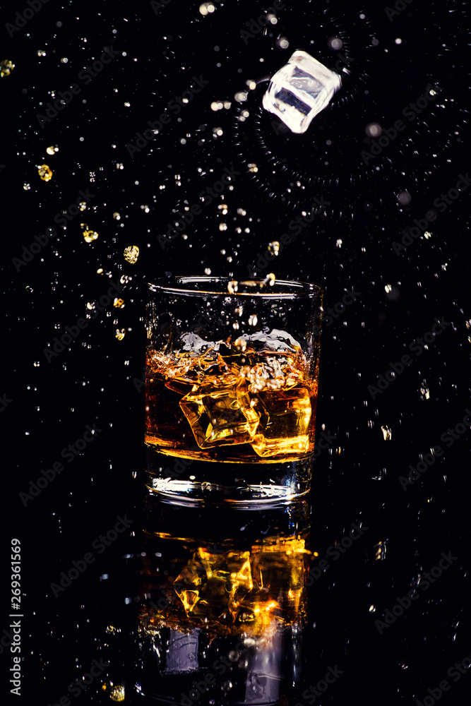 Isolated shot of whiskey with splash on black background Isolated shot of whiskey with splash on black background