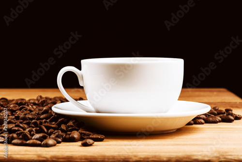 coffee cup, coffee beans on dark background