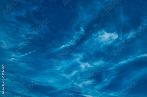 Concept photo of a blue sky background with feather clouds on a sunny day with a dry sun. © Вячеслав Чичаев