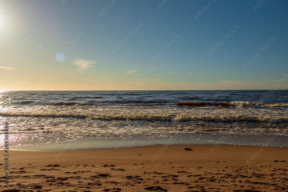 Calm Baltic sea seashore beach background in golden hour