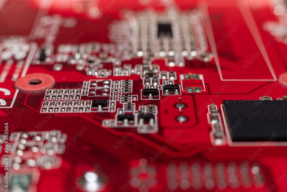 Transistors from the back of the video card under the graphic core. Macro shooting of a red microcircuit. Transistors from the back of the video card under the graphic core. Macro shooting of a red microcircuit.