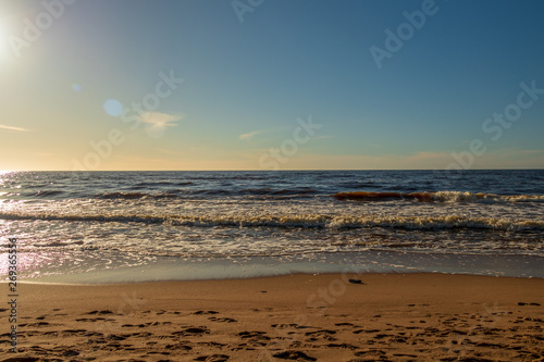 Calm Baltic sea seashore beach background in golden hour