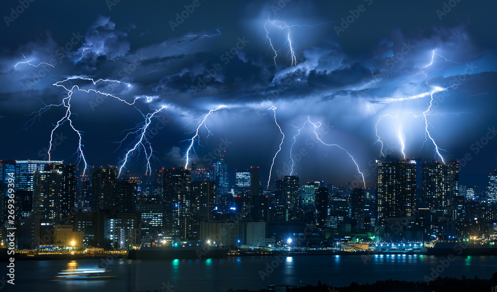 Fototapeta premium Lightning storm over city in blue light