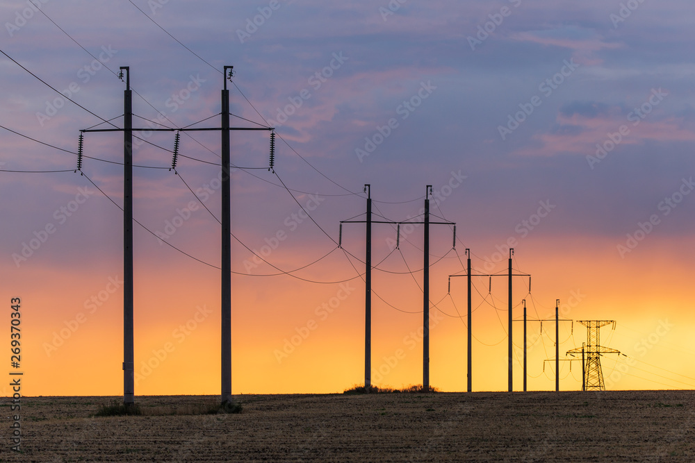 Epic sunset with rural landscape with high-voltage line