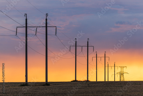 Epic sunset with rural landscape with high-voltage line
