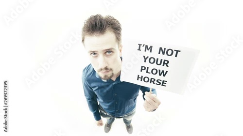 Man holding sign I'm Not Your Plow Horse 4K. Extreme wide shot top view of person head in focus while pull up a sign. White background. photo