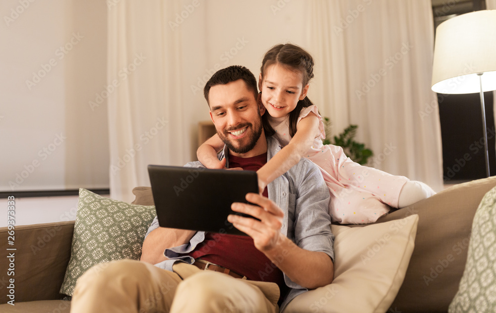 family, fatherhood and technology concept - happy father and little daughter with tablet pc computer at home family, fatherhood and technology concept - happy father and little daughter with tablet pc computer at home