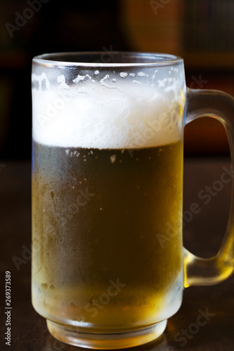 Cold beer on a wooden table in a restaurant