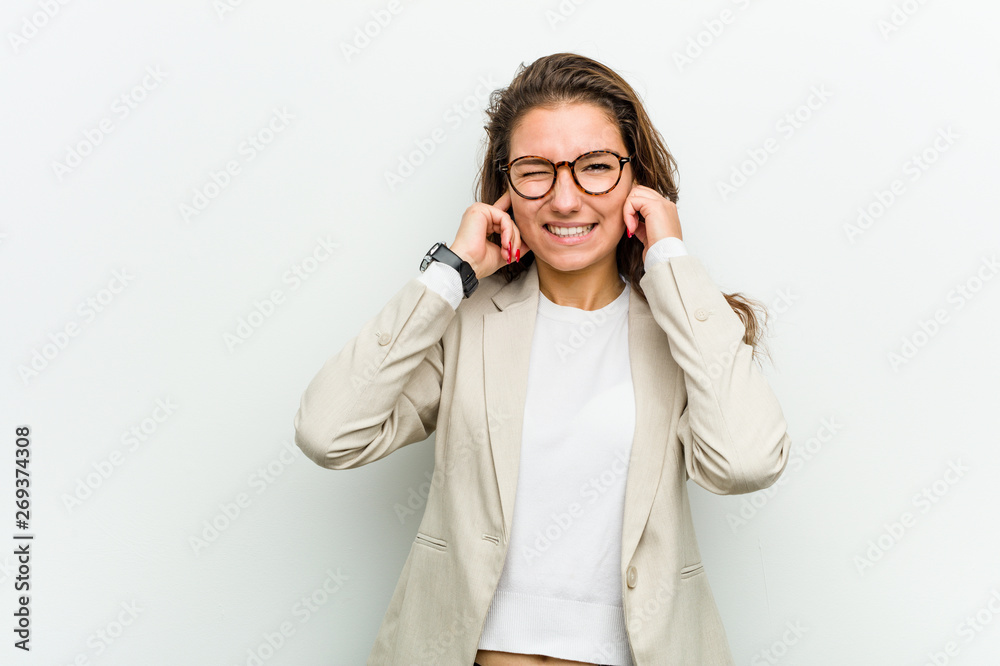 Young european business woman covering her ears with her hands. Young european business woman covering her ears with her hands.
