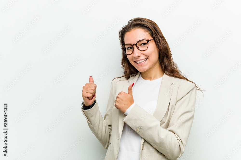 Young european business woman raising both thumbs up, smiling and confident. Young european business woman raising both thumbs up, smiling and confident.