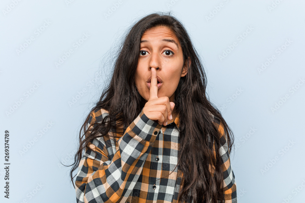 Young cool indian woman keeping a secret or asking for silence. Young cool indian woman keeping a secret or asking for silence.