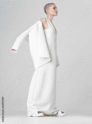 Stylish woman taking off white jacket