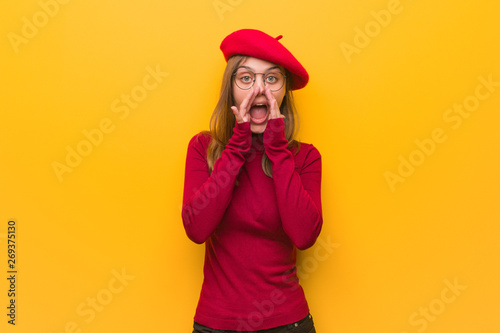Young french artist woman shouting something happy to the front