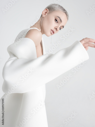 Young model putting on white jacket