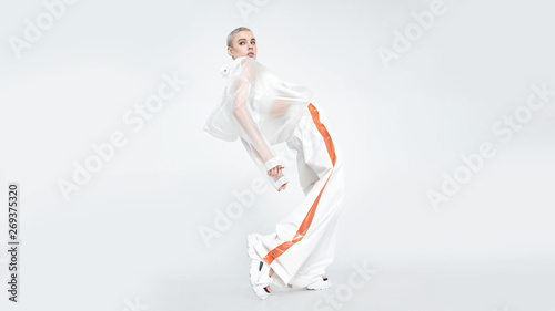 Sensual futuristic lady dancing and looking away