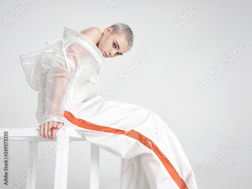 Futuristic female sitting on stool