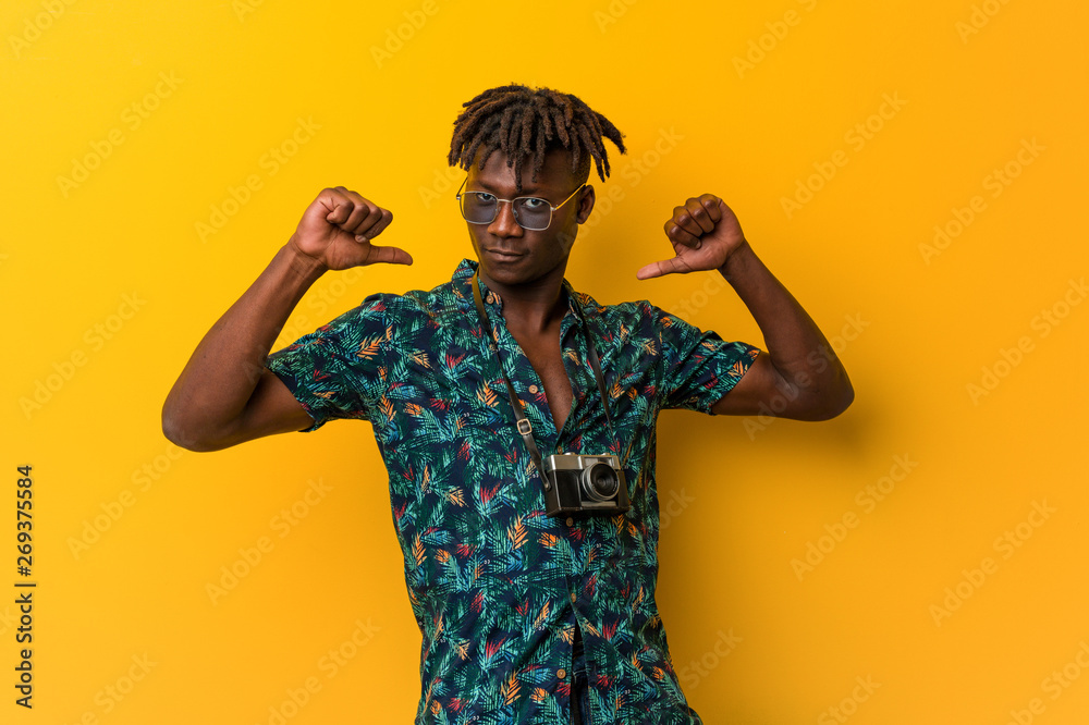 Young black rasta man wearing a vacation look feels proud and self confident, example to follow.