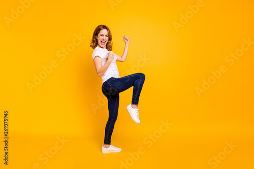 Full length body size view photo nice lovely people shout yeah free time weekend summer travel fortune luck celebrate content delighted raise fists modern denim clothes isolated yellow background