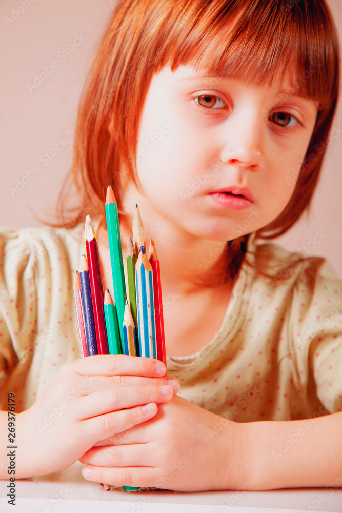 Cute little child girl with colored pencils. Art, creative, talent, education, happy childhood concept. Cute little child girl with colored pencils. Art, creative, talent, education, happy childhood concept.