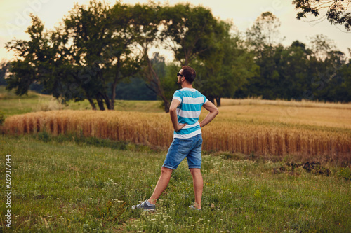 Man enjoying and relaxing in wheat field. Nature concept.