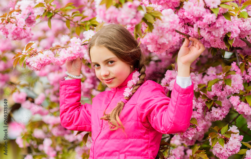 Little girl enjoy spring. Kid on pink flowers of sakura tree background. Kid enjoying pink cherry blossom. Tender bloom. Pink is the most girlish color. Bright and vibrant. Pink is my favorite Little girl enjoy spring. Kid on pink flowers of sakura tree background. Kid enjoying pink cherry blossom. Tender bloom. Pink is the most girlish color. Bright and vibrant. Pink is my favorite