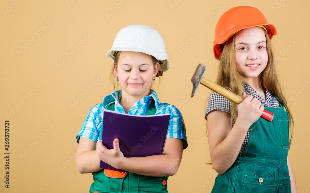 Foreman inspector. Repair. happy children. Future career. Little kids in  helmet with tablet and hammer. Labor day. 1 may. small girls repairing  together in workshop. Tired after hard working day Stock-Foto