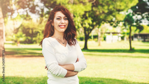 Portrait of young joyfully beautiful girl outdoors, happily smiling in the nature forest on the sunset background