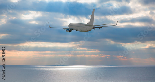 White passenger airplane in the clouds - Airplane take off from the airport - Travel by air transport