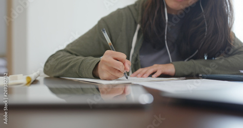 Woman do revision with cellphone at home photo