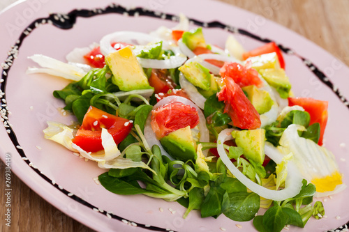 Tasty salad of avocado, grapefruit, tomatoes and corn salad