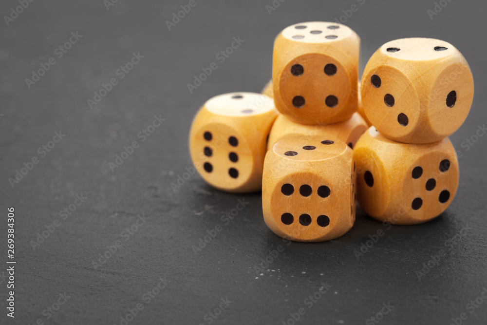 Rolling dice on a wooden desk Rolling dice on a wooden desk