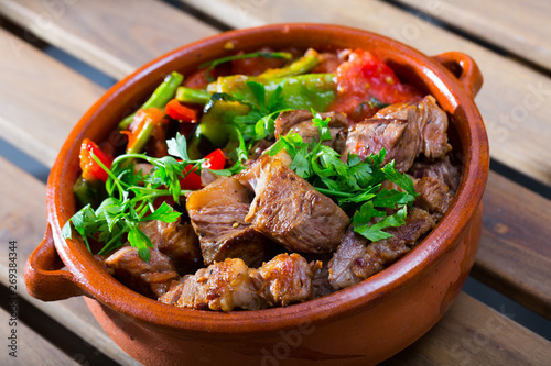 Tasty dish ghiveci of bulgarian cuisine of beef  with paprika  at clay pot photo