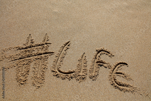 hashtag written by hand in the sand photo