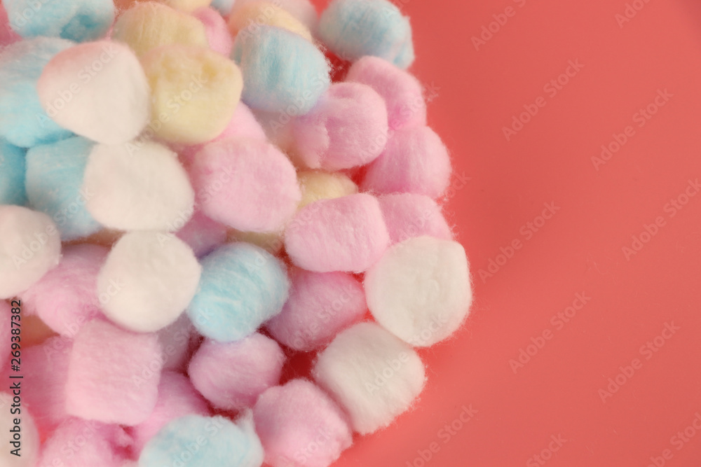 Multicolored cotton wool on a pink background Multicolored cotton wool on a pink background