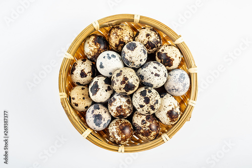 a basket of quail eggs on a white background