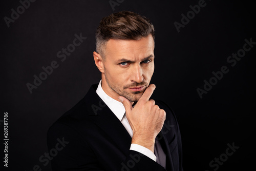 Close-up portrait of his he nice-looking attractive minded imposing executive corporate specialist expert shark agent broker development touching chin isolated over dark black background © deagreez