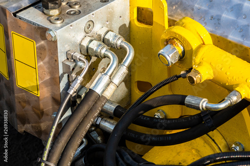 Close up of pipe system of hydraulic valves in agricultural machinery