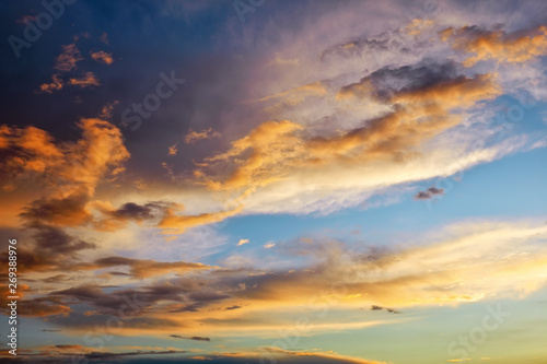 Beautiful dark fluffy cloudy sky. Sunset light. © es0lex