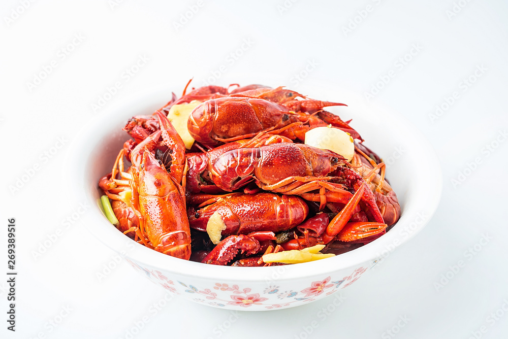 A large bowl of bright red delicious braised crayfish on a white background A large bowl of bright red delicious braised crayfish on a white background