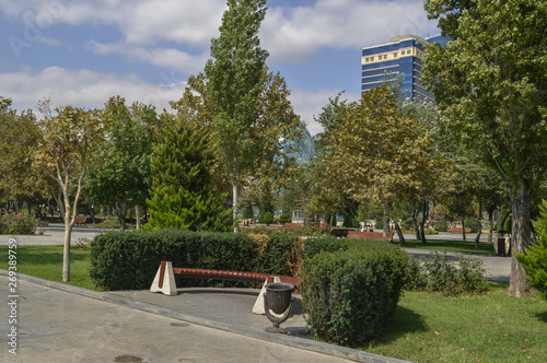 bench and trash can placed inside bushes at Baku Bulvar photo