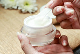 Facial care cream on natural background