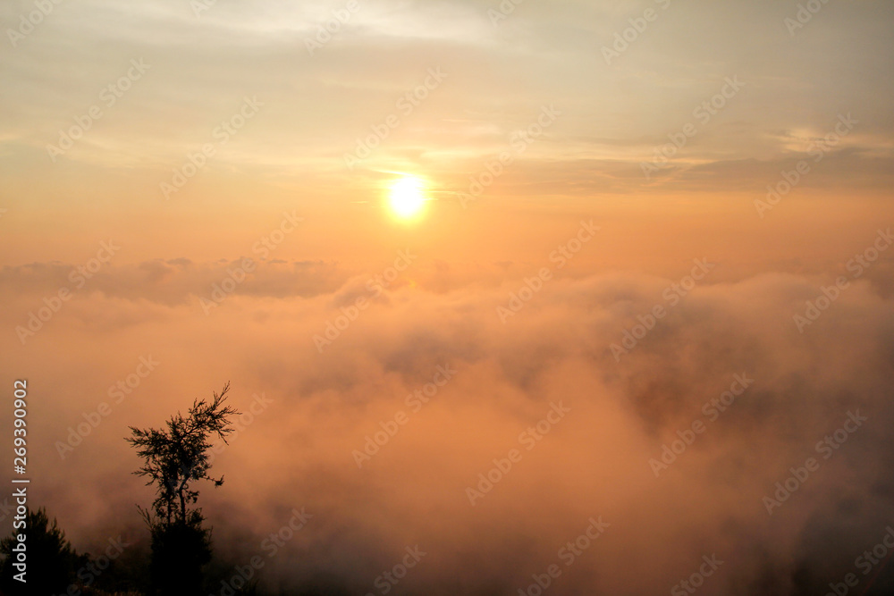 Beautiful structure of clouds on sky, mountain landscape with dense fog at sunset on horizon of beauty natural environment. Panorama of amazing sunrise view show sun rays through clouds over mountain.