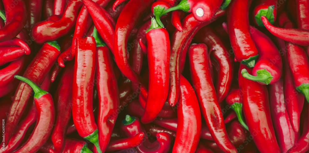 Fresh hot red chilli pepppers in the market as a food background
