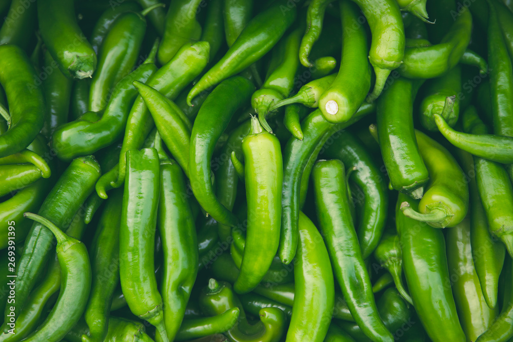 Fresh hot green chilli pepppers in the market as a food background Fresh hot green chilli pepppers in the market as a food background