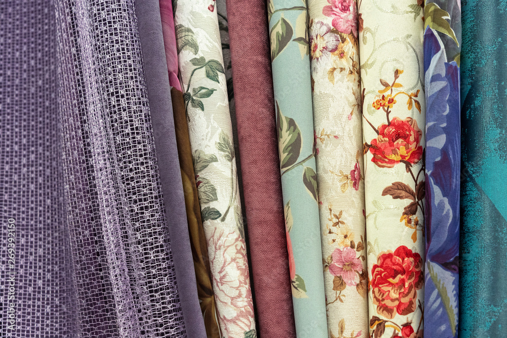 Curtains with floral ornament in the shop window. Fabric with floral pattern. Curtains with floral ornament in the shop window. Fabric with floral pattern.